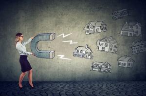 Businesswoman with a magnet attracting house buyers and household votes