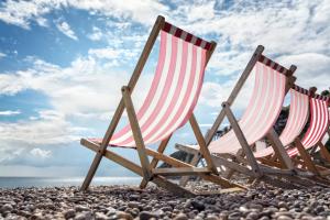 Deck chairs on the beach at the seaside in summer
