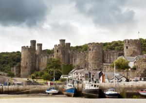Conwy Castle and harbor at ebb-tide, Wales