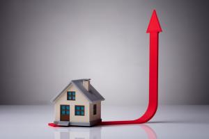 Close-up Of House Model On Red Arrow Showing Upward Direction