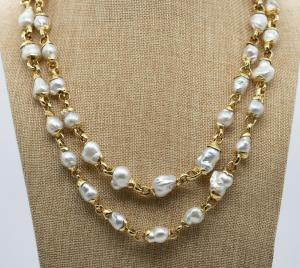 Spectacular Elizabeth Gage pearl and gold necklace, 55 inches long, with baroque South Sea pearls set in heavy molten 18kt gold shell caps to each end.
