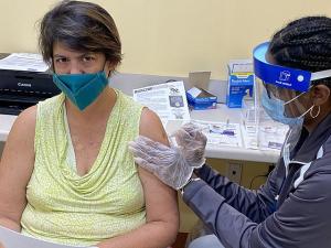 A photograph of a person receiving a vaccine against COVID-19 Source: Wikimedia Commons