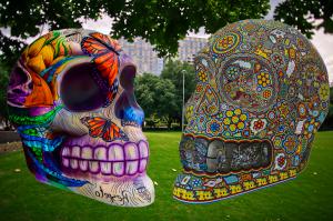Rendering of large painted skull sculptures in a city park