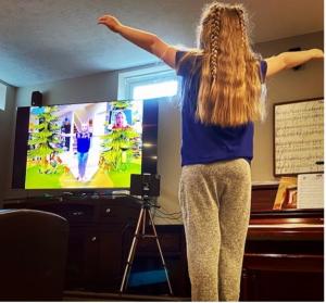 Child interacts with augmented-reality content to perform therapy exercises from home.