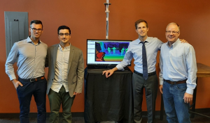 From left to right, Spaulding researcher Dr. Federico Parisi, Barrett Engineer Dr. Alexandros Lioulemes, Congressman Jake Auchincloss, and Barrett CEO Bill Townsend, who will lead the effort. In the background is an AI-powered realtime image tracking the