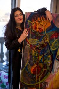 Artist Shalimar Sharbatly with one of her works