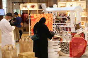 two people looking at showcased export-ready product at Indonesia Pavilion