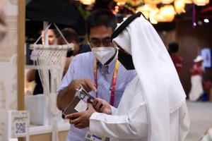 Man shows phone to arabic man