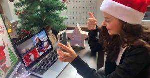 An employee participates in a virtual team building activity for her team's virtual holiday party.