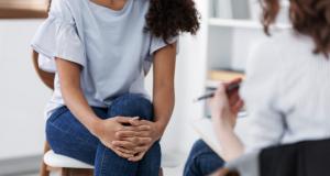 girl crossing hands over knees anxious