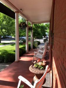 The inviting front porch features rocking chairs in a quaint setting