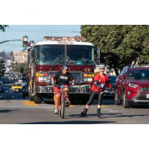 Dr. Christine Ichim rollerblading across San Francisco accompanied by Lt. Julie DeJarlais and SFFD engines to raise awareness of the importance of cancer prevention in the fire services