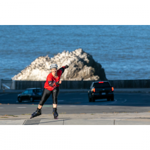 Dr. Christine Ichim rollerblading across San Francisco accompanied by Lt. Julie DeJarlais and SFFD engines to raise awareness of the importance of cancer prevention in the fire services. Photo by Doug Zimmerman