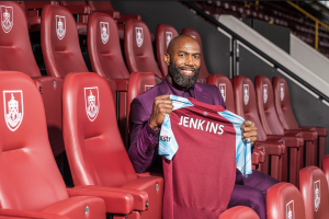 Two-time Super Bowl Champion and 3x Pro Bowl Saints Safety Malcolm Jenkins holds up his very own Burnley F.C. jersey.