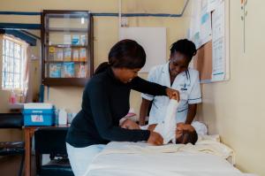 Postnatal care in Kenya  - mother with nurse