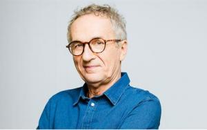 A man in glasses and a denim shirt looks at the camera. People in Oregon can get help with Social Security Disability benefits from Harder, Wells, Baron & Manning.