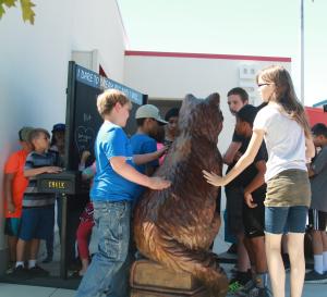 Dare To Dream Big by Chris Navarro  bronze sculpture is loved by children.