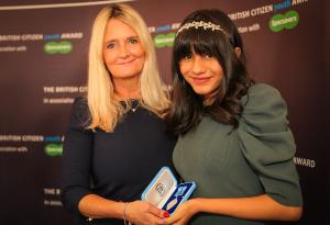 Freya Thakral receiving the British Citizen Award from Nicky Cox MBE