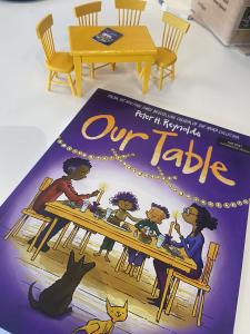 Peter Reynolds' book entitled OUR TABLE sits next to mini yellow table, featured in book