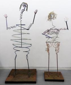 Pair of life-size figural kinetic metal sculptures – one male and one female, comprised of painted metal rods, six feet tall and 80 inches tall (estimate: $800-$1,200).