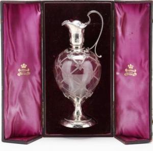 Silver and cut glass 12-inch-tall wine vessel in the original silk-lined case, with insignias by Appointment to King, Elkington and Co. (estimate: $2,500-$5,000).