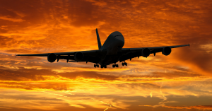 Beautiful sunset on the background: An airplane takes off, connected globally by the Helix SmartSIM™.