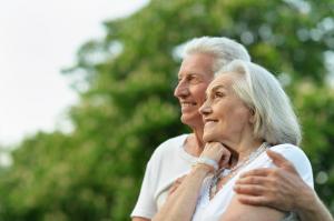older couple smiling together outside