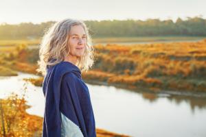 woman by river looking at camera