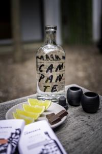 Bottle of Mezcal Campante shown with chocolate bars from Aranda Honest Chocolate.