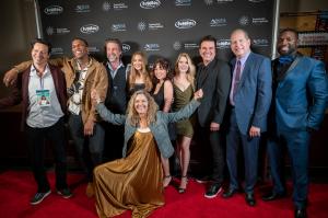 WAKE UP make World Premiere at 2021 Sunscreen Film Festival West - Filmmaker Janet Craig (kneeling) celebrates on the red carpet with Cast & Crew on November 6, 2021