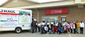 Standing in front of the Project SHARE food bank building in Niagra Falls, Canada, volunteers from the Iglesia Ni Cristo (Church Of Christ) are seen standing with the boxes of donated goods which they are donating to the food bank, in connection with the 