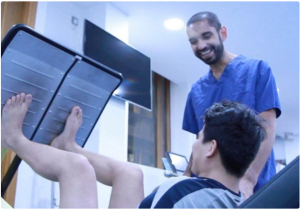 Dr Seth of LBSM support a patient with their recovery — Source — LBSM Website