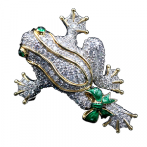 Platinum gold and diamond frog brooch, attributed to Donald Chaflin for Tiffany & Co., signed plate, having two cabochon emerald eyes and green enamel bow, pave set diamond.