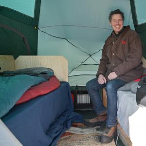 Reed Construction CEO Bill Birck Checks Out His Rooftop Tent at Project H.O.O.D.'s 10th Annual Tent-A-Thon