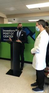 Photo taken in lobby of Investors Bank Post COVID-19 Care Center and shows VP Brian Gomez at podium speaking to doctors & healthcare professionals