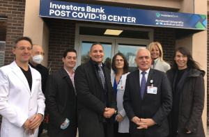 Photo taken outside of Investors Bank Post COVID-19 Care Center show healthcare professionals from the medical center plus men and women executives from the bank