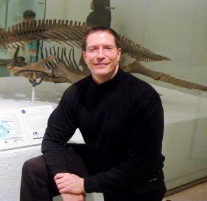 Max Hawthorne, author and songwriter, with a plesiosaur at the AMNH
