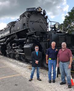 Michael and Chris Arnold with UP's Ed Dickens (center) in front of the 4014 at UP’s Geneva Illinois facility for the BigBoy 16 huge drive wheel bearing treatment.