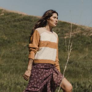Woman in sweater and skirt combination expressing her style