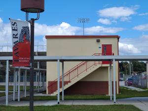 White concrete, two-story classroom addition with concrete stairs