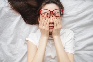 Girl with glasses fatigued