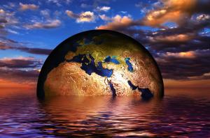 Planet earth half submerged  in water, blue sky and clouds