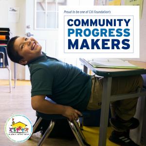 Child leaning back in chair smiling with text that reads Proud to be one of Citi Foundation's Community Progress Makers