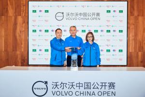 Three Chinese golf officials pose with the glass Volvo China Open trophy