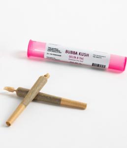 a photo of two Bubba Kush Delta-8 THC Pre-Rolls laying out of their packaging, which is pink