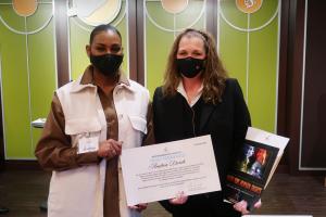 Bennette Seaman (right) of the Church of Scientology Kansas City presents Andrea Dorch, Director of Civil Rights and Equal Opportunity for Kansas City, Missouri, with a human rights award.