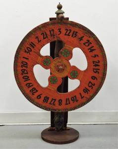 Large, 19th century wood and metal American folk art game wheel, numbered 1 thru 30, 36 inches tall (estimate: $500-$800).