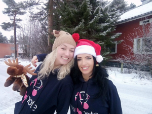 Huggnote founders - sisters Jacqui and Perry Meskell in a festive pic with snow and wearing Huggnote hoodies with their logo of two music notes facing each other as though hugging