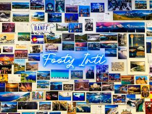 A neon blue sign of the words Footy Intl surrounded by colorful postcards from different cities around the world
