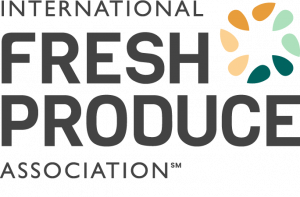 The image is a logo for International Fresh Produce Association which features the words fresh produce in bold, the logo also includes a circle of seeds that resemble petals.